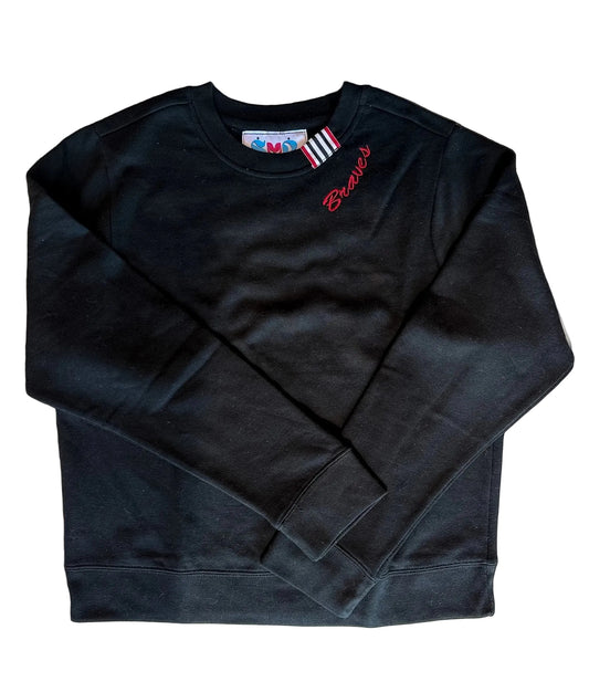 A black long-sleeve crewneck sweatshirt with red script embroidery reading 'Braves' on the left chest, laid flat on a light beige background.